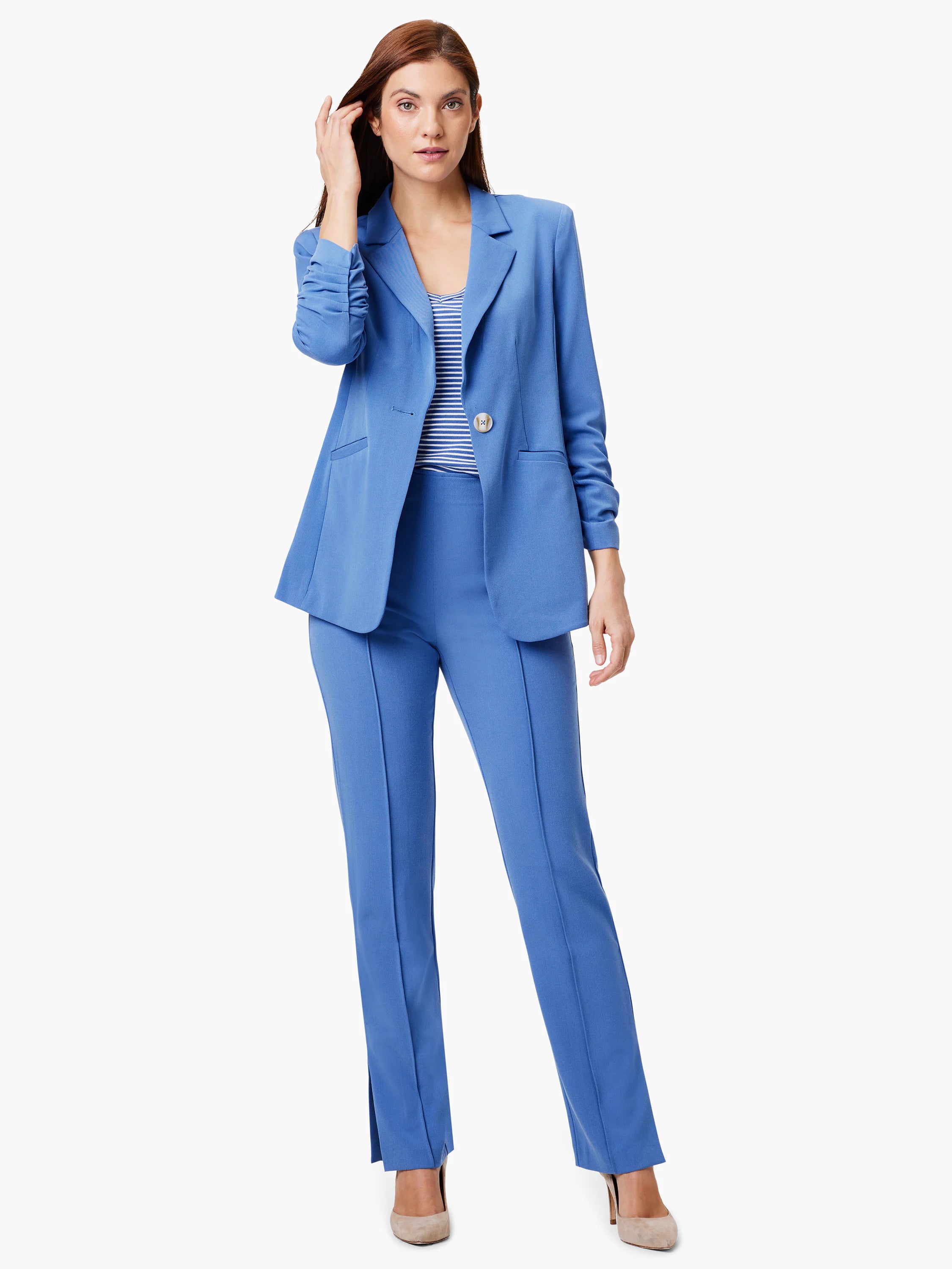Here's alt text describing the image:
"Woman in light blue blazer & pantsuit. Jacket has scrunch sleeves, one button. ...
