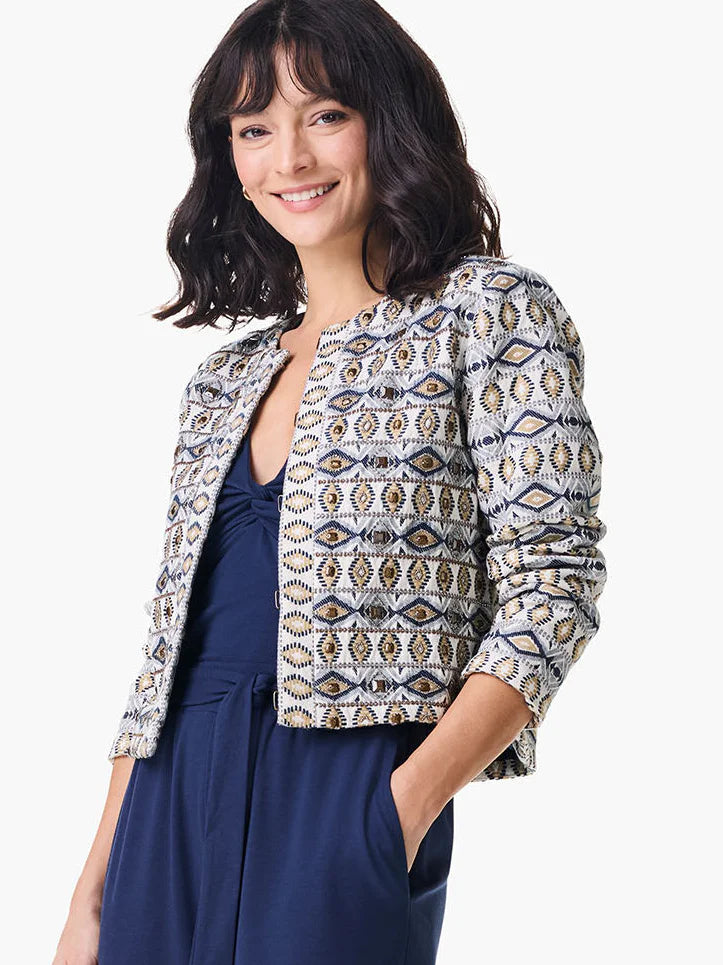 Cream jacket with navy, gold, and beige geometric pattern. Short sleeves, cropped length.
