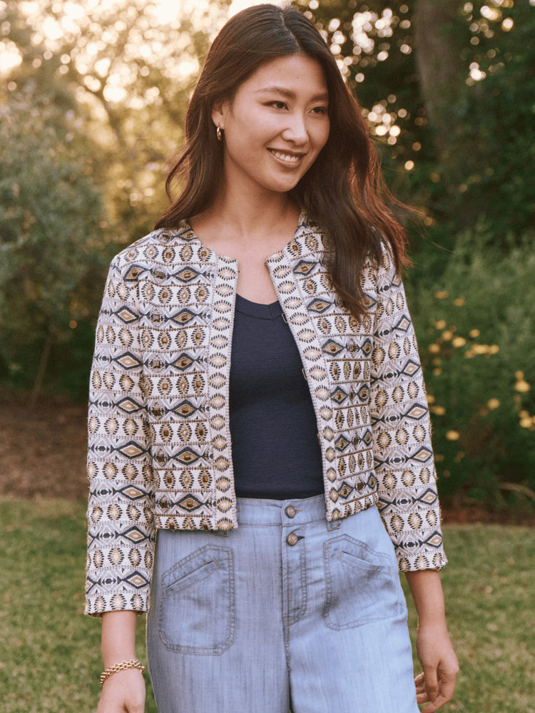 Cream jacket with gold, blue, and gray geometric pattern. Three-quarter sleeves.