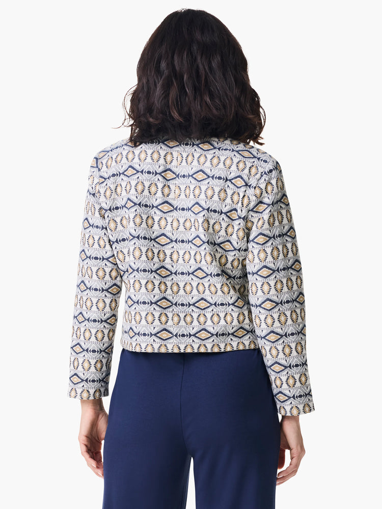 Here's alt text for the image, under 125 characters:
"Seaside Glimmer Jacket, rear view. Off-white base with navy and...
