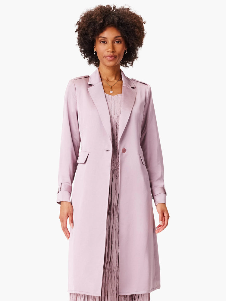Lilac trench coat, single-breasted, long sleeves with tabbed cuffs. Features patch pockets.
