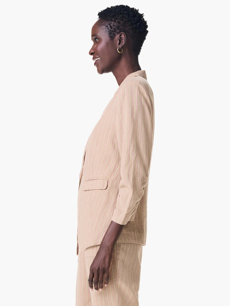 Beige blazer with thin, pale pink stripes. Three-quarter sleeves. Side profile view.