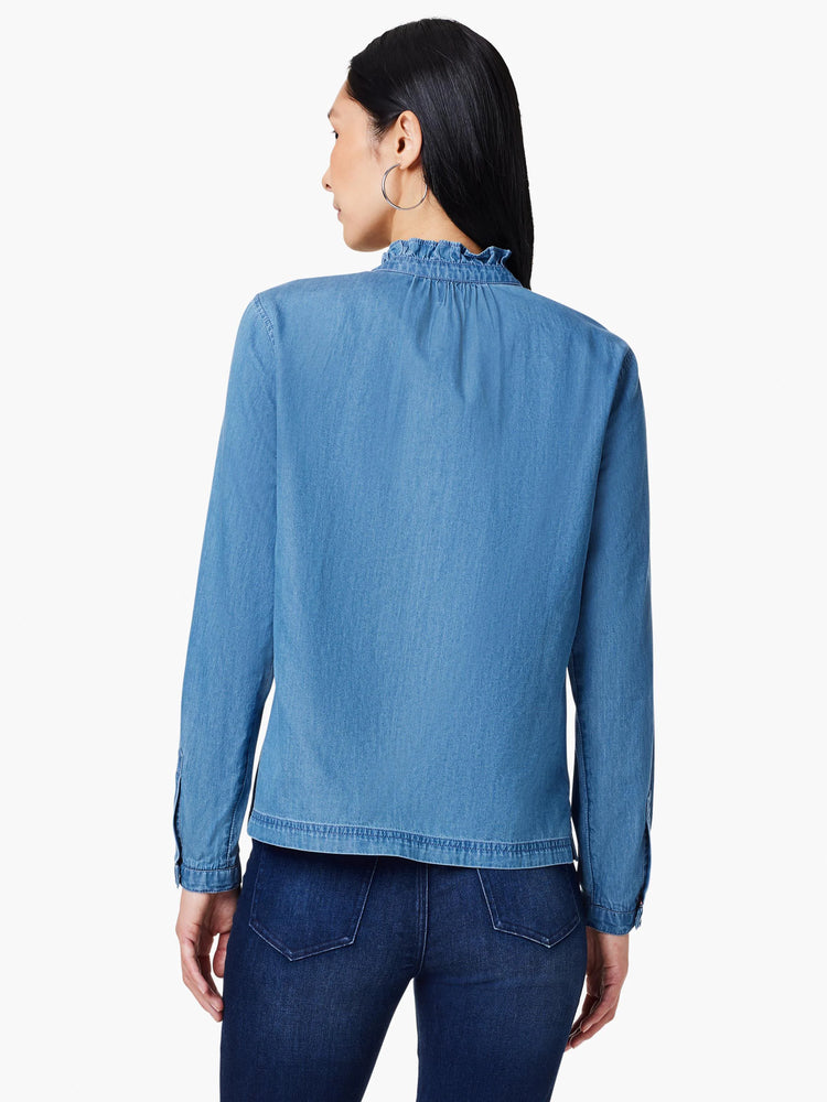 Here's alt text for the image, keeping it concise and accessible:
"Back view of light blue denim shirt. Features ruffle...