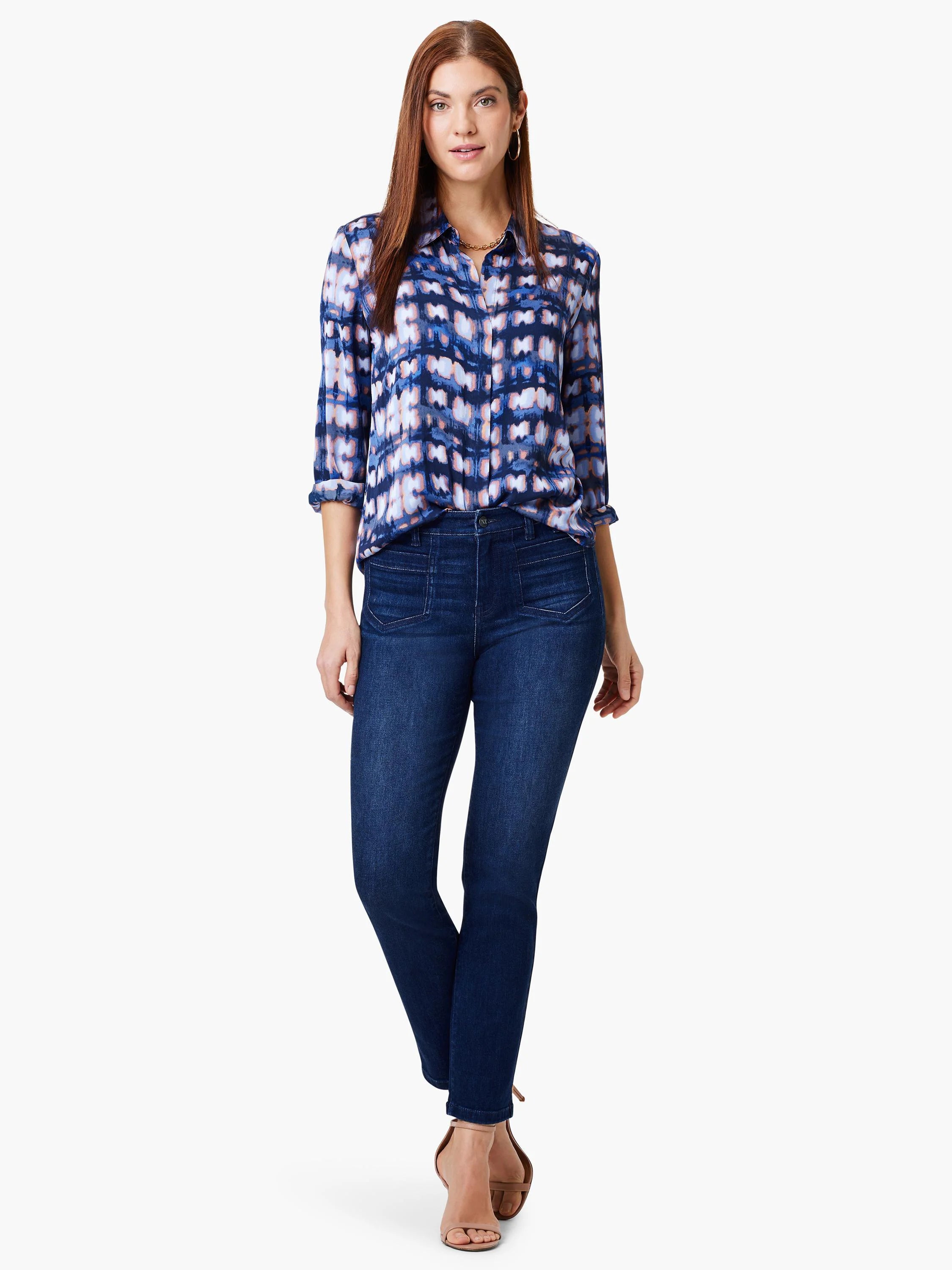 Woman in blue, white, and pink patterned shirt; dark wash jeans.