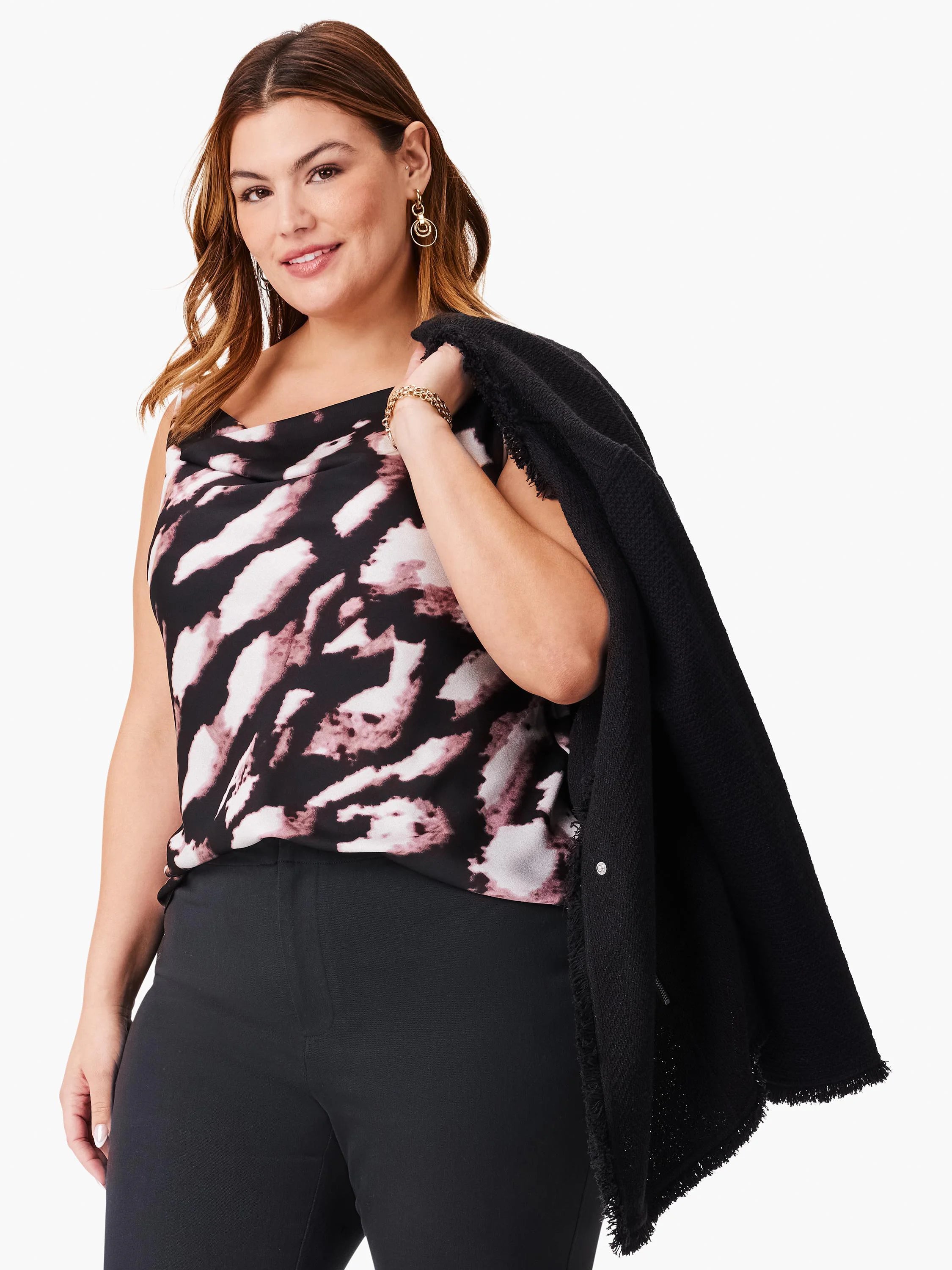 Cowl-neck sleeveless top in dark-base print with mauve/pink abstract design. Model also wears black pants & jacket.
