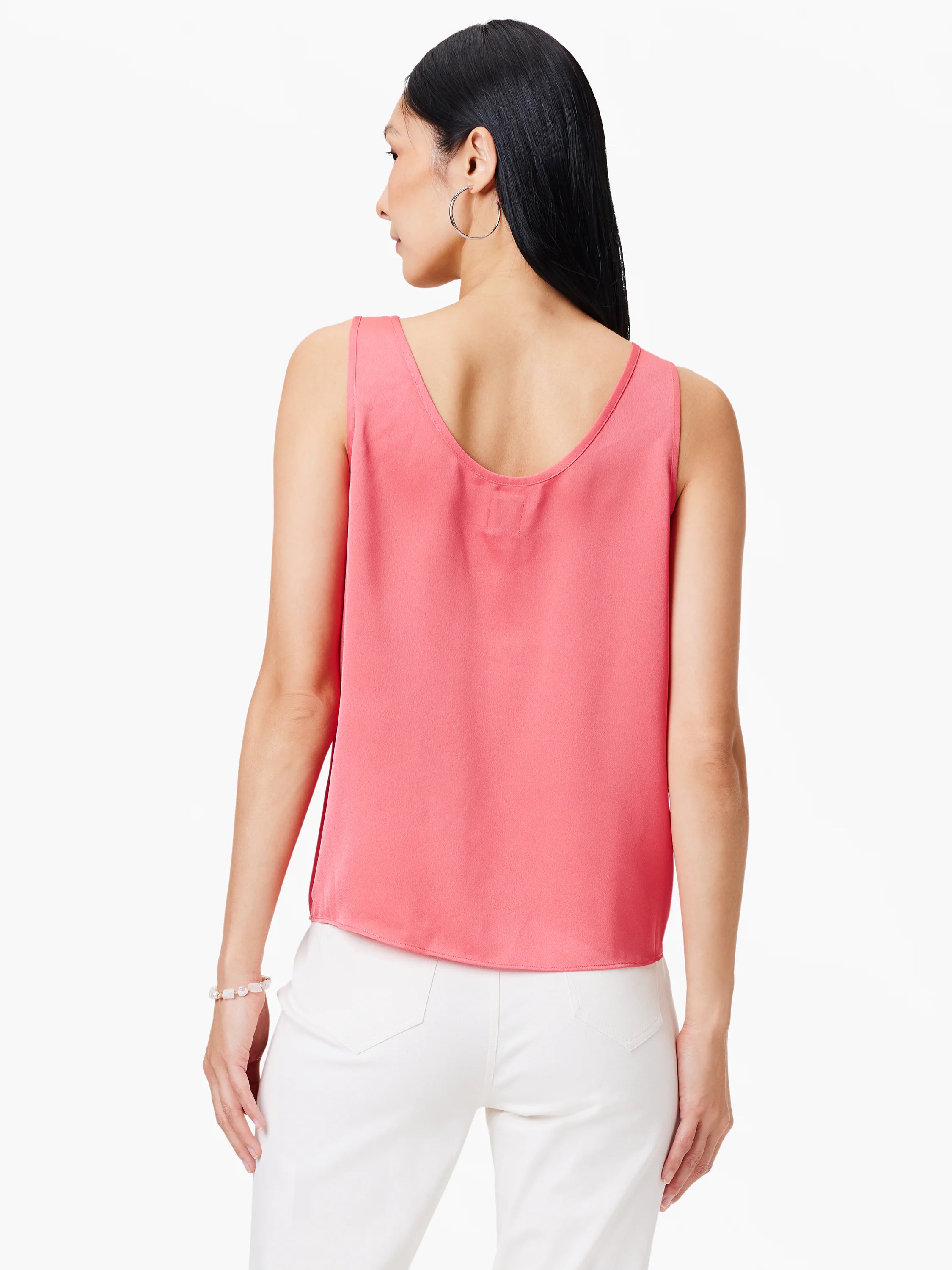 Coral pink sleeveless tank with a deep scoop back. Smooth fabric texture visible.