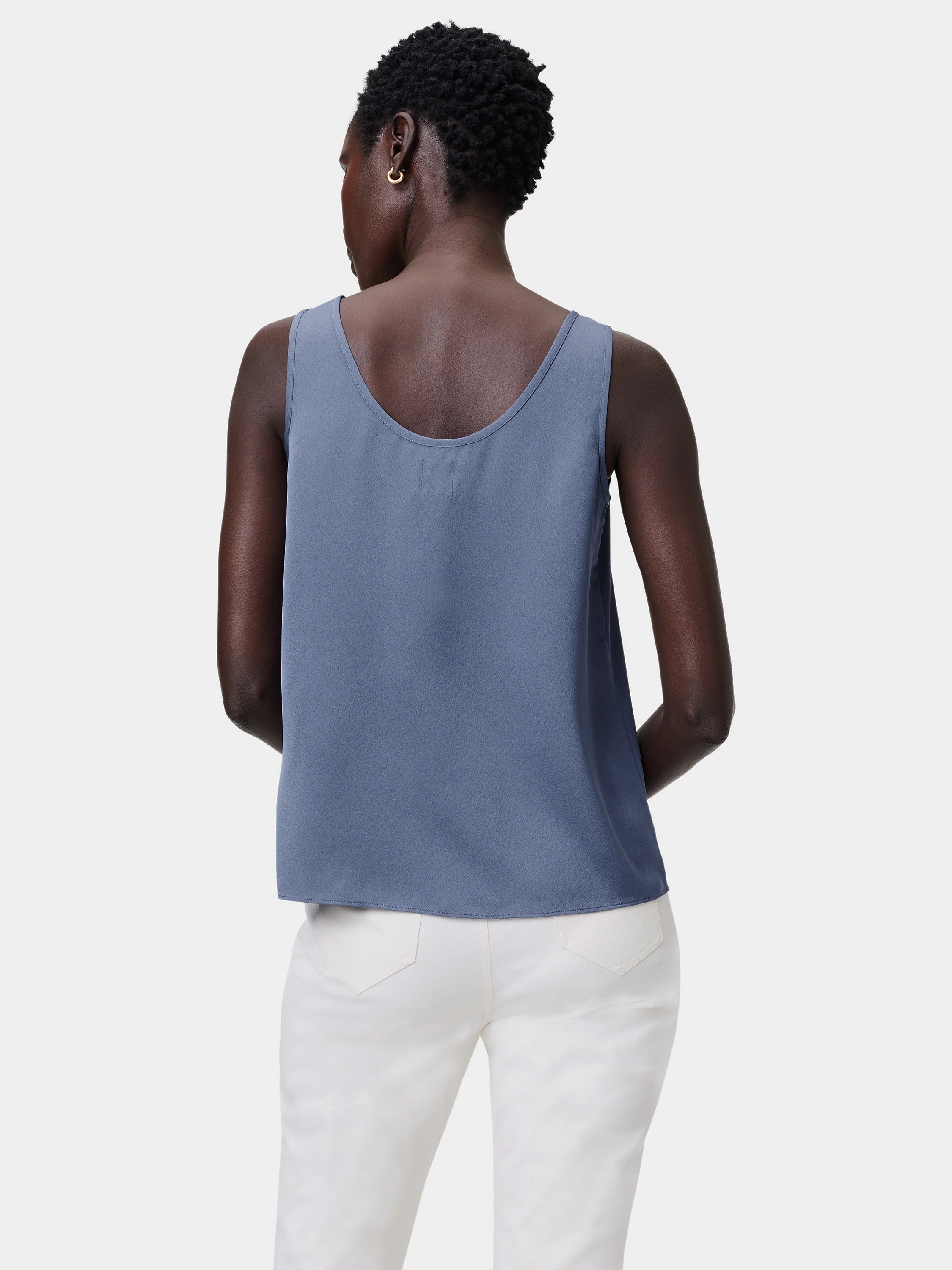 Slate blue scoop tank with relaxed fit, scoop back, and curved hem, shown from behind.