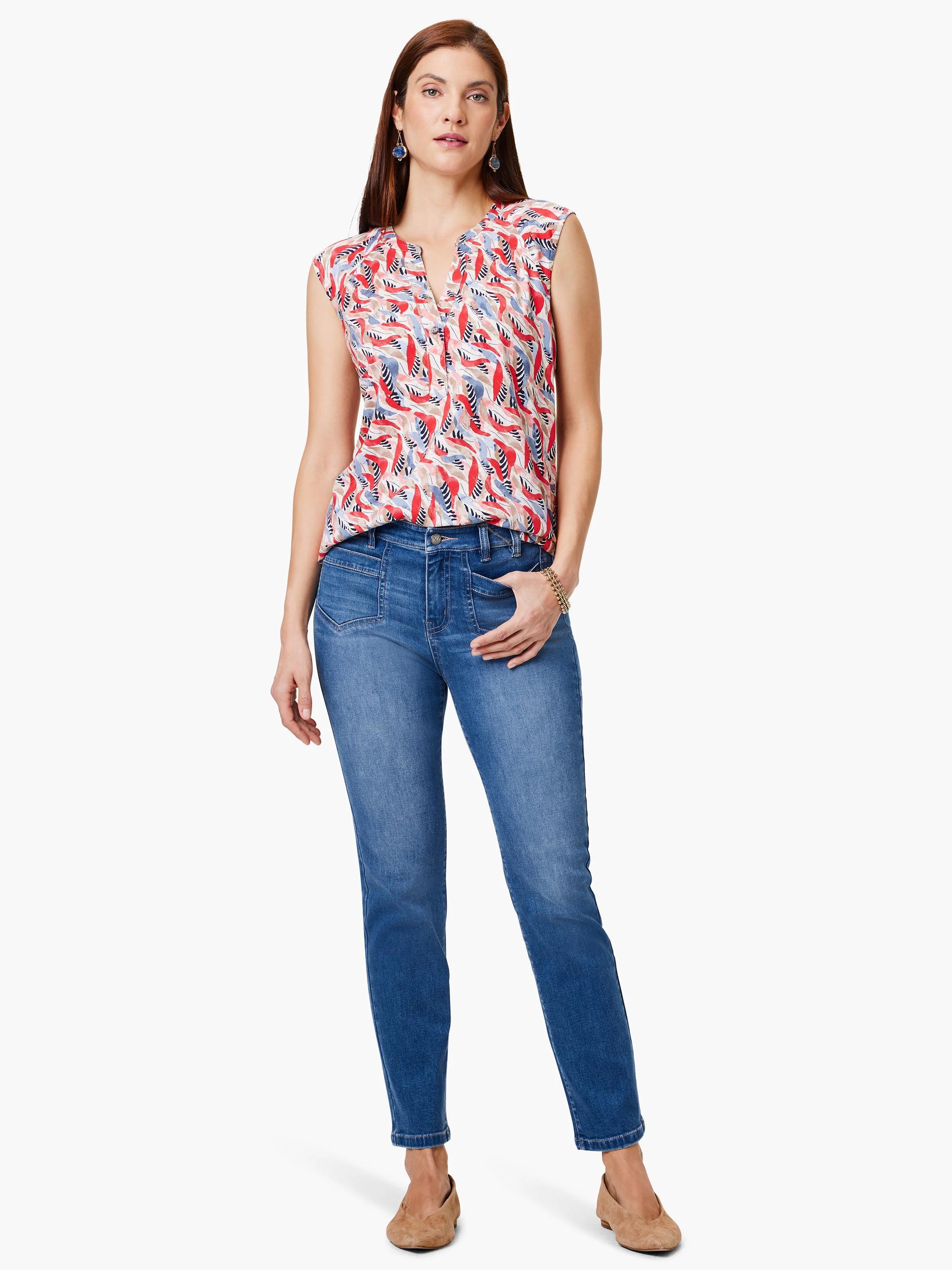 Woman modeling sleeveless coral, blue, and white patterned top and mid-rise straight-leg jeans. Tan flats.