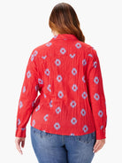 Red long-sleeve shirt with a crinkled texture and a repeating blue geometric pattern.