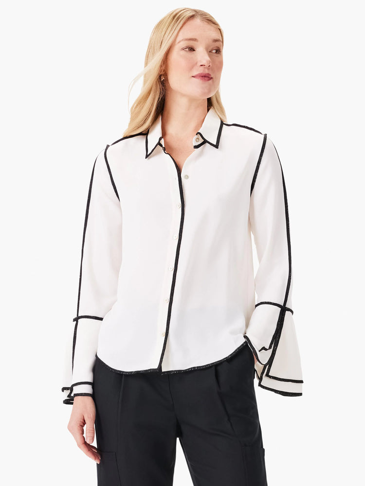 Off-white long-sleeve button-down shirt with black trim along the collar, placket, cuffs, and sleeve seams. Bell sleeves.