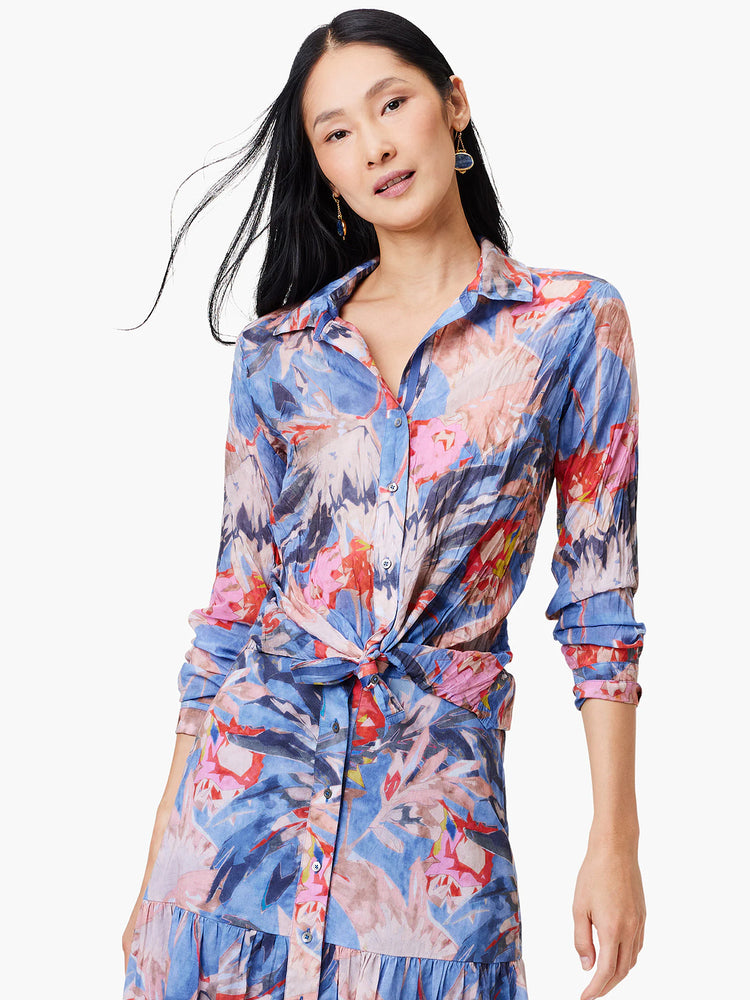Blue crinkle shirt with pink and red abstract floral print. Long sleeves, button front, belted waist.