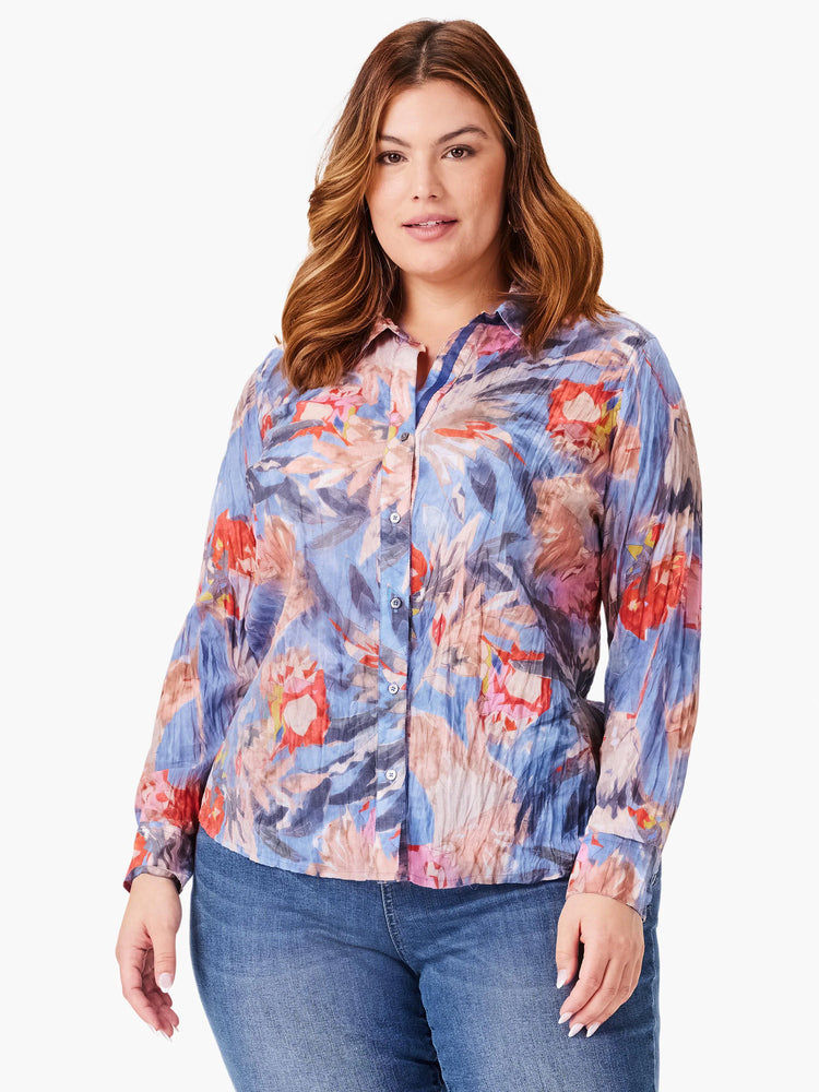 Long-sleeve button-up shirt; blue, pink, orange floral print on crinkled fabric.