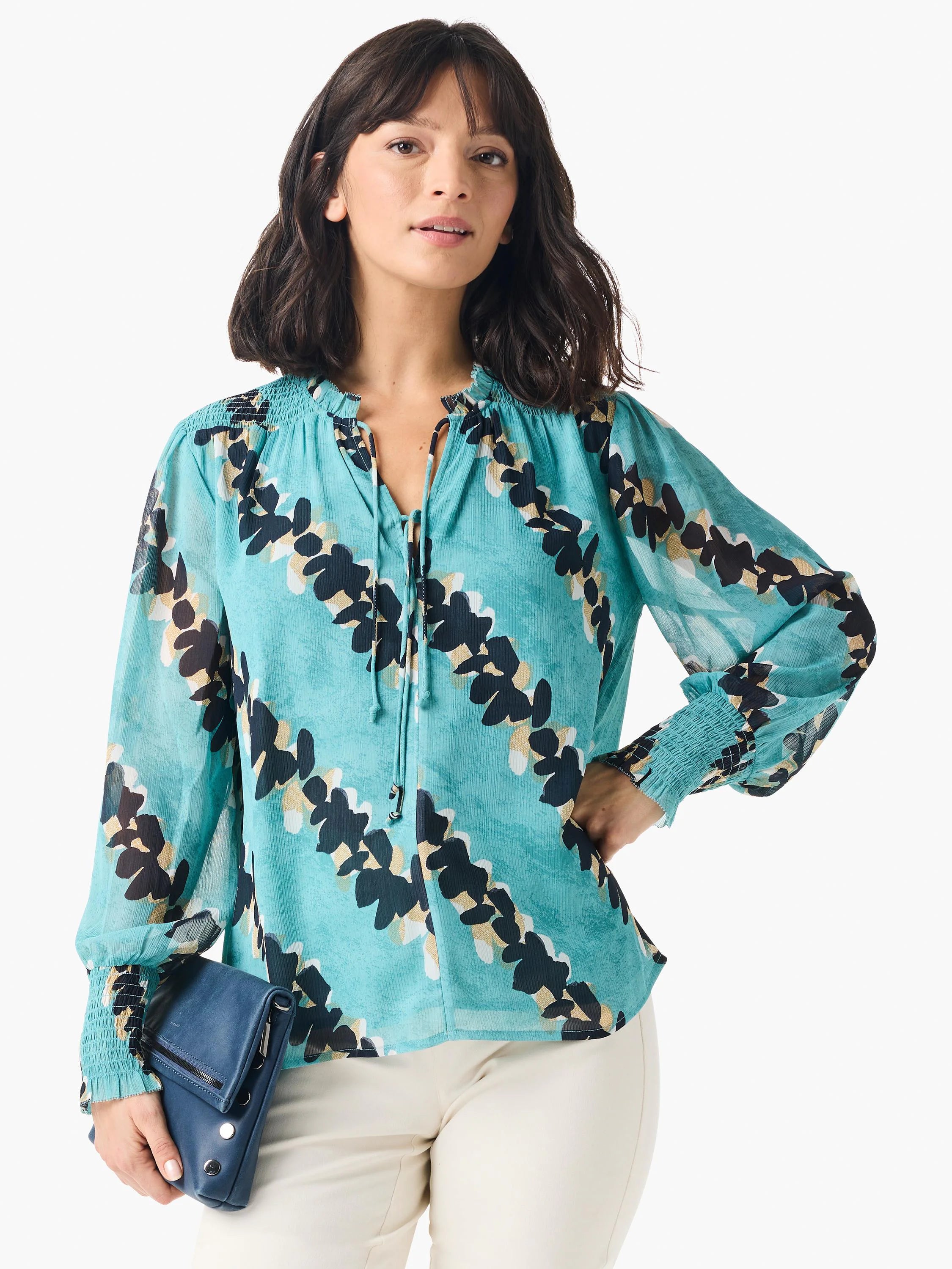 Teal long-sleeve blouse with a V-neck and abstract dark-leaf print on a lighter teal background. Elastic cuffs. ...