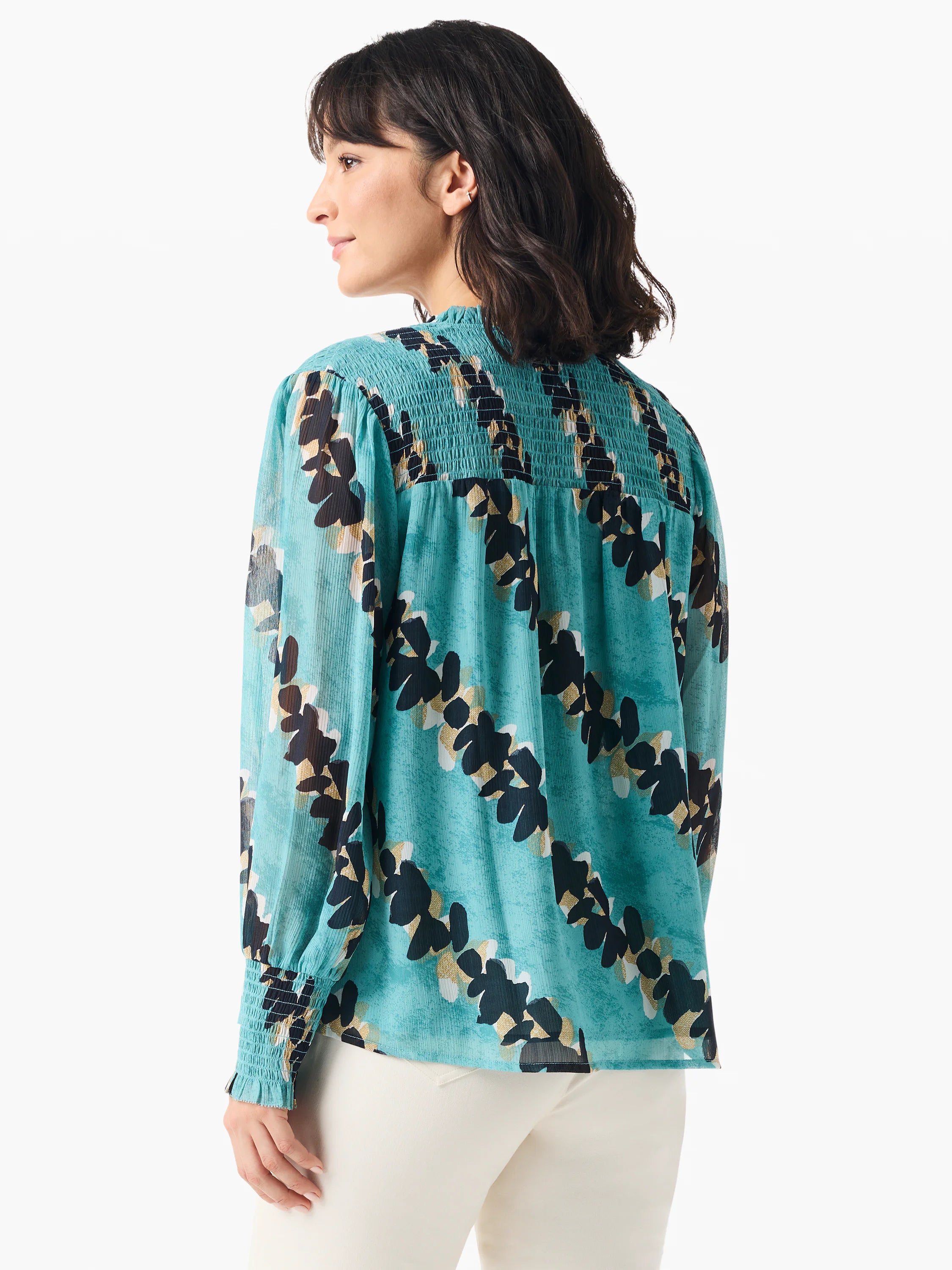 Teal long-sleeve blouse. Black and gold leaf print. Smocked neckline and cuffs. Sheer fabric.