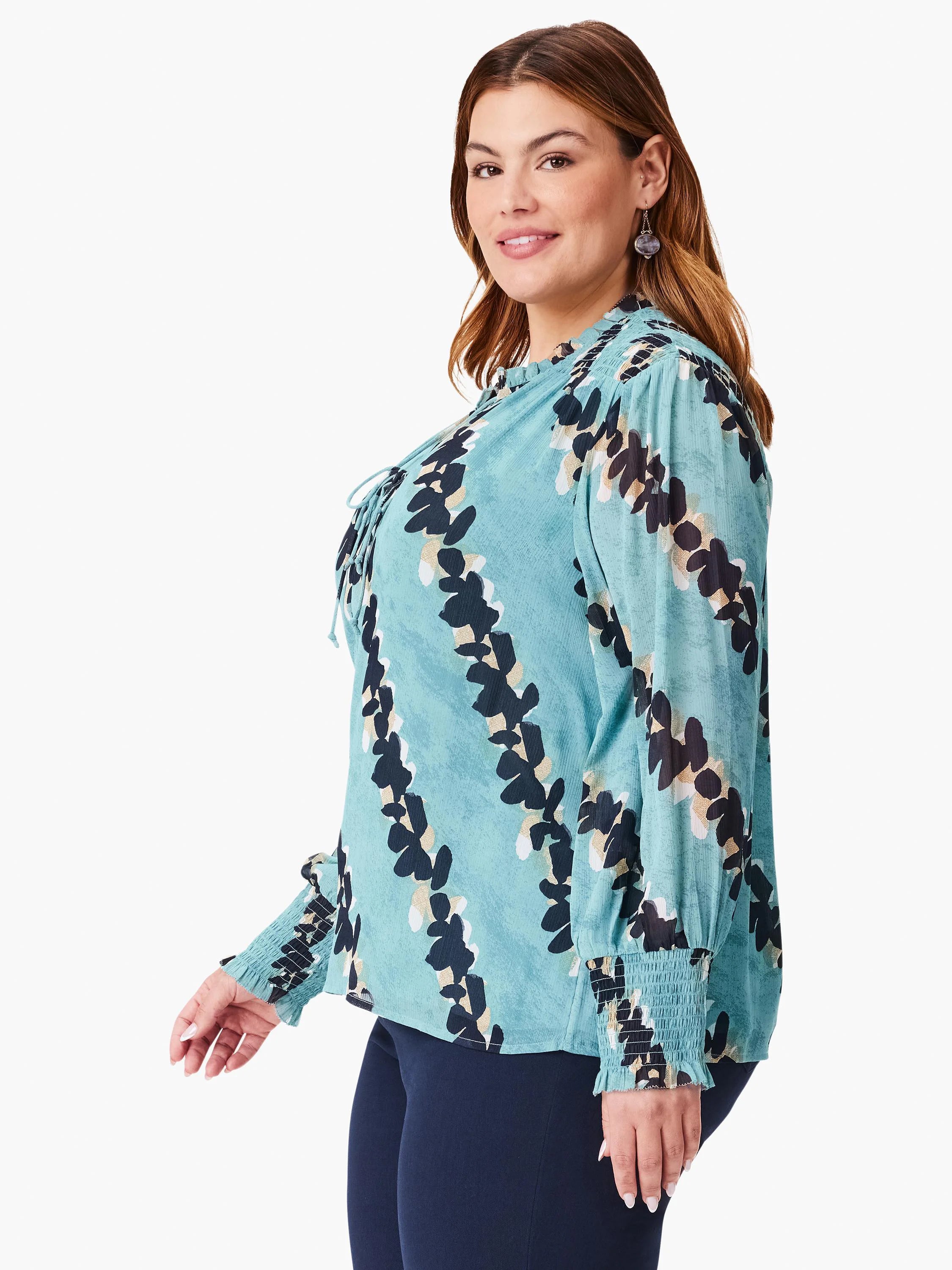 Teal top with black and beige leaf print, long sleeves with smocked cuffs, and a keyhole neckline.