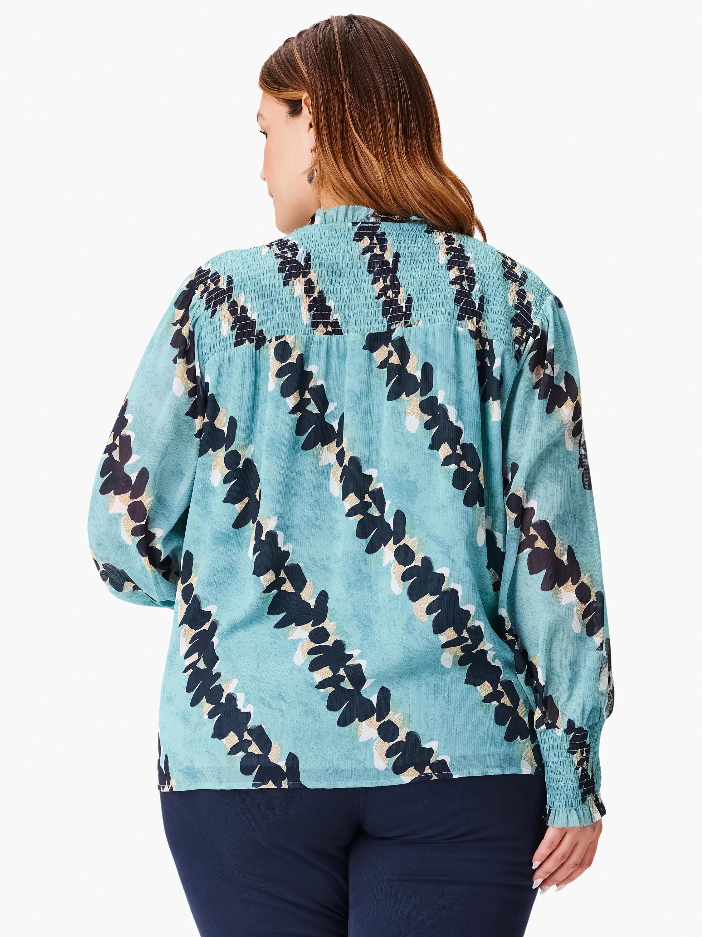 Teal blouse with black and beige abstract leaf print. Smocked neckline and elastic cuffs. Long sleeves.
