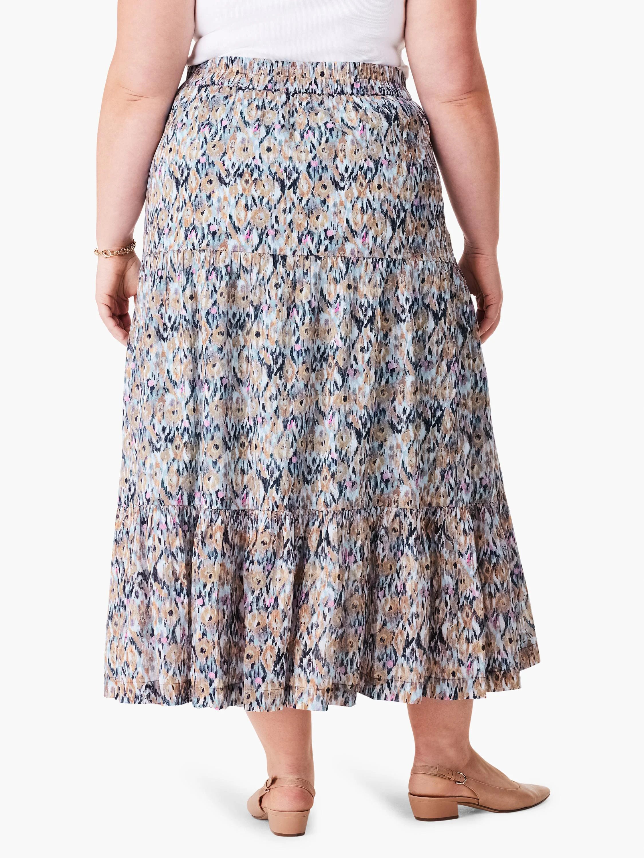 Tiered maxi skirt in blue, brown, and tan ikat print. Elastic waistband.