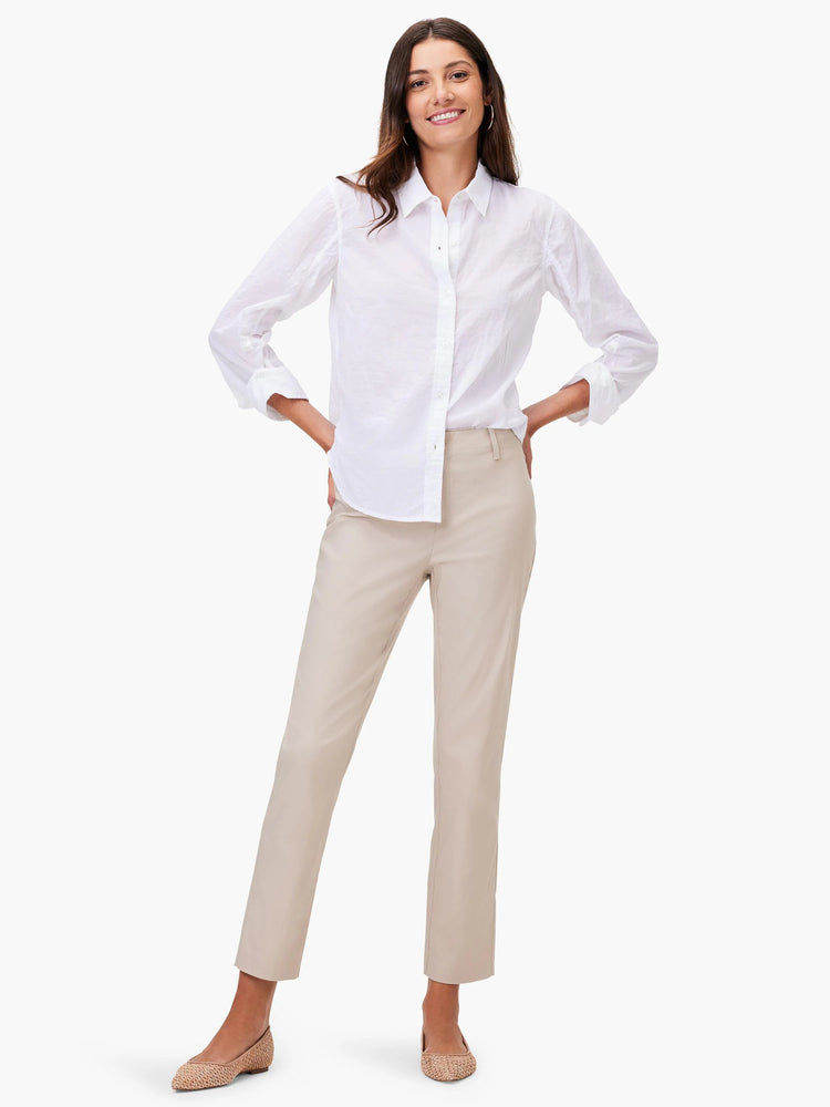 Beige straight-leg pants on a model. The pants are shown from a full-body shot.