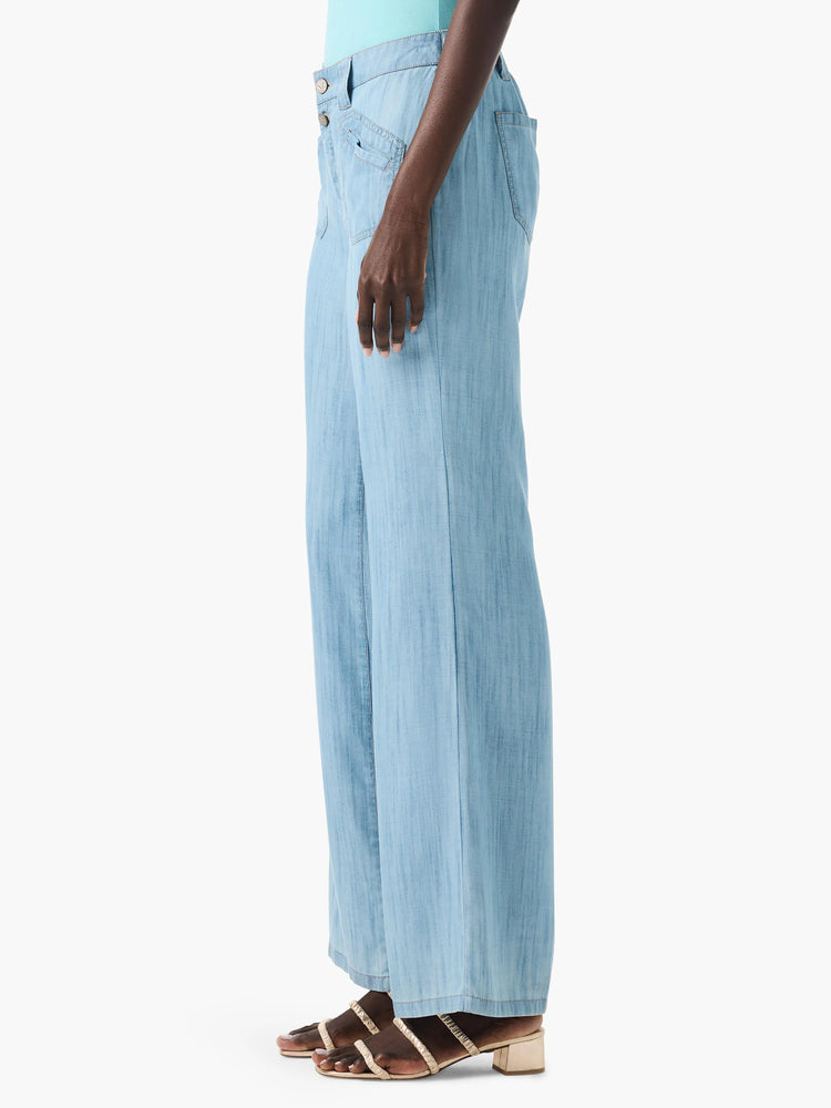 Light blue, wide-leg jeans shown on a model. Features a button fly and side pockets.