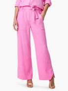 Pink wide-leg pants with elasticated waist, tie belt, and patch pockets. Side slits at hem.
