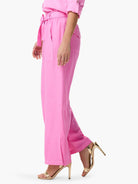 Bright pink drapey wide-leg utility pant with a tied waist and side patch pockets.