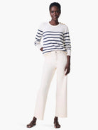 Off-white wide-leg jeans with a raw-edge hem.