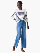 Medium blue wide-leg cropped jeans with frayed hems.