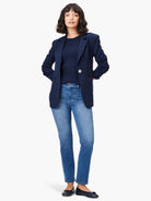 Light blue straight-leg jeans with visible front patch pockets on a model.