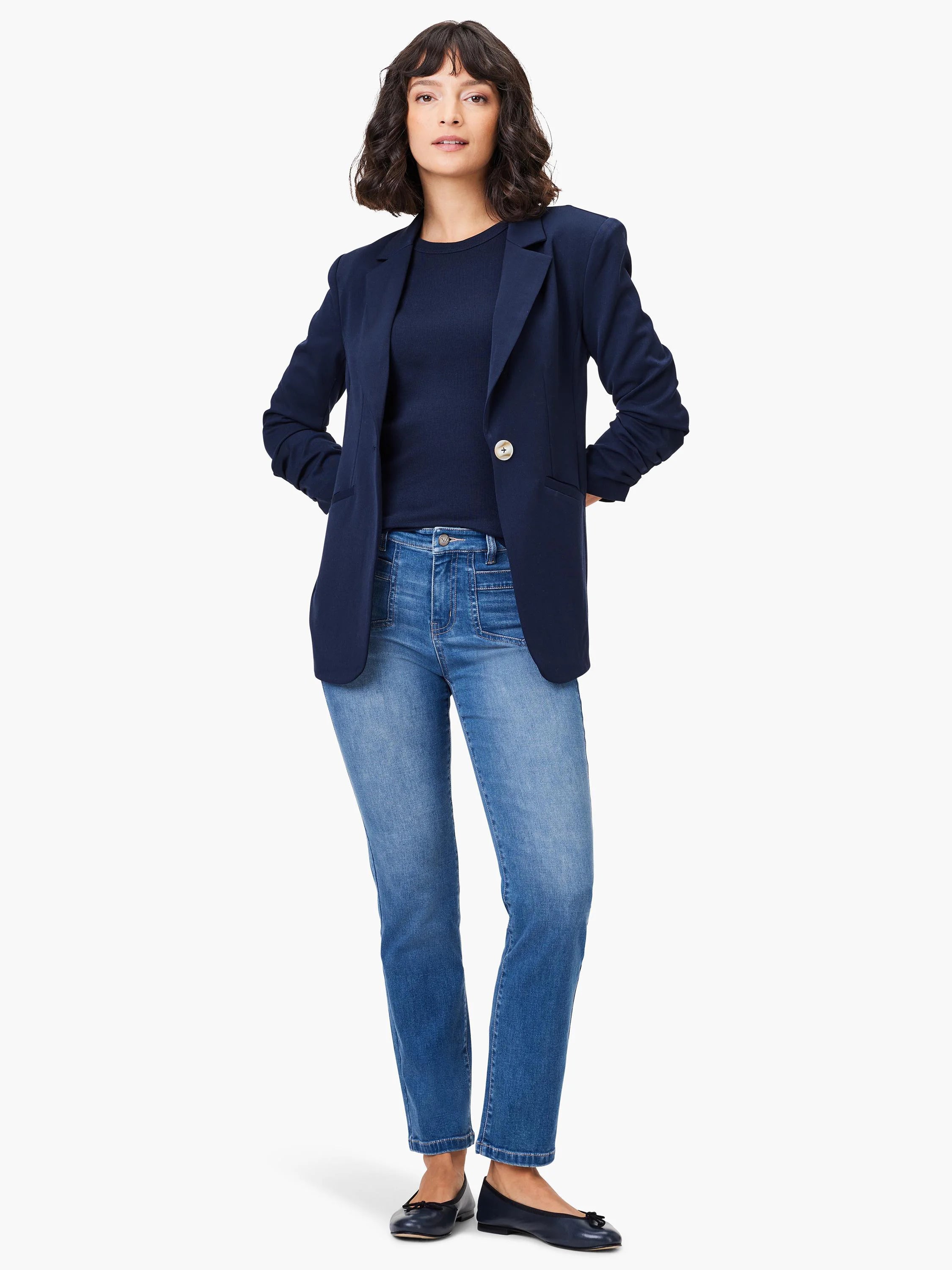Light blue straight-leg jeans with visible front patch pockets on a model.