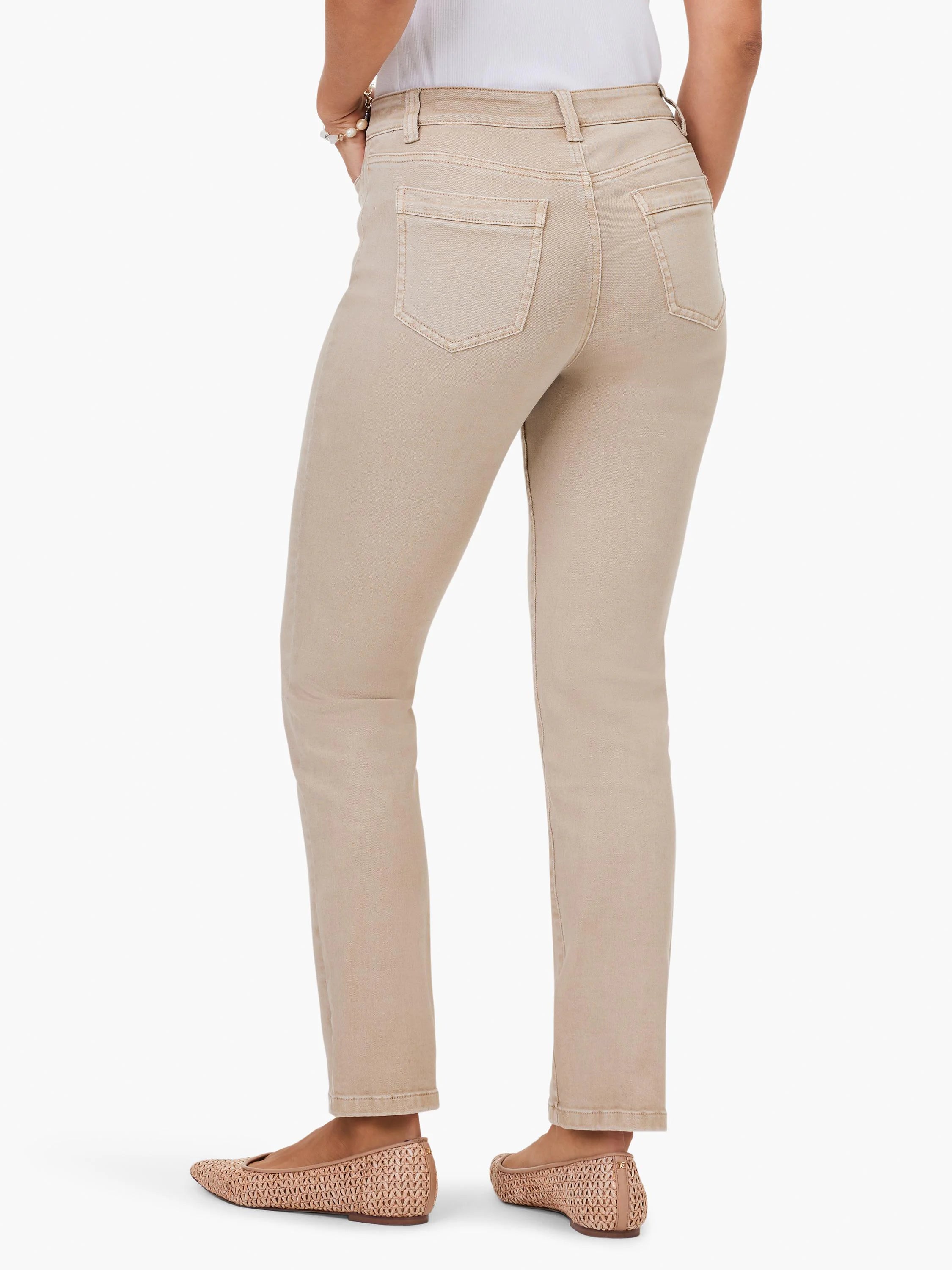 Light tan mid-rise straight jeans, rear view. Features back patch pockets with subtle darker stitching.