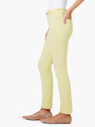 Light yellow mid-rise straight jeans, worn by a person. Shows front pockets and classic denim details.