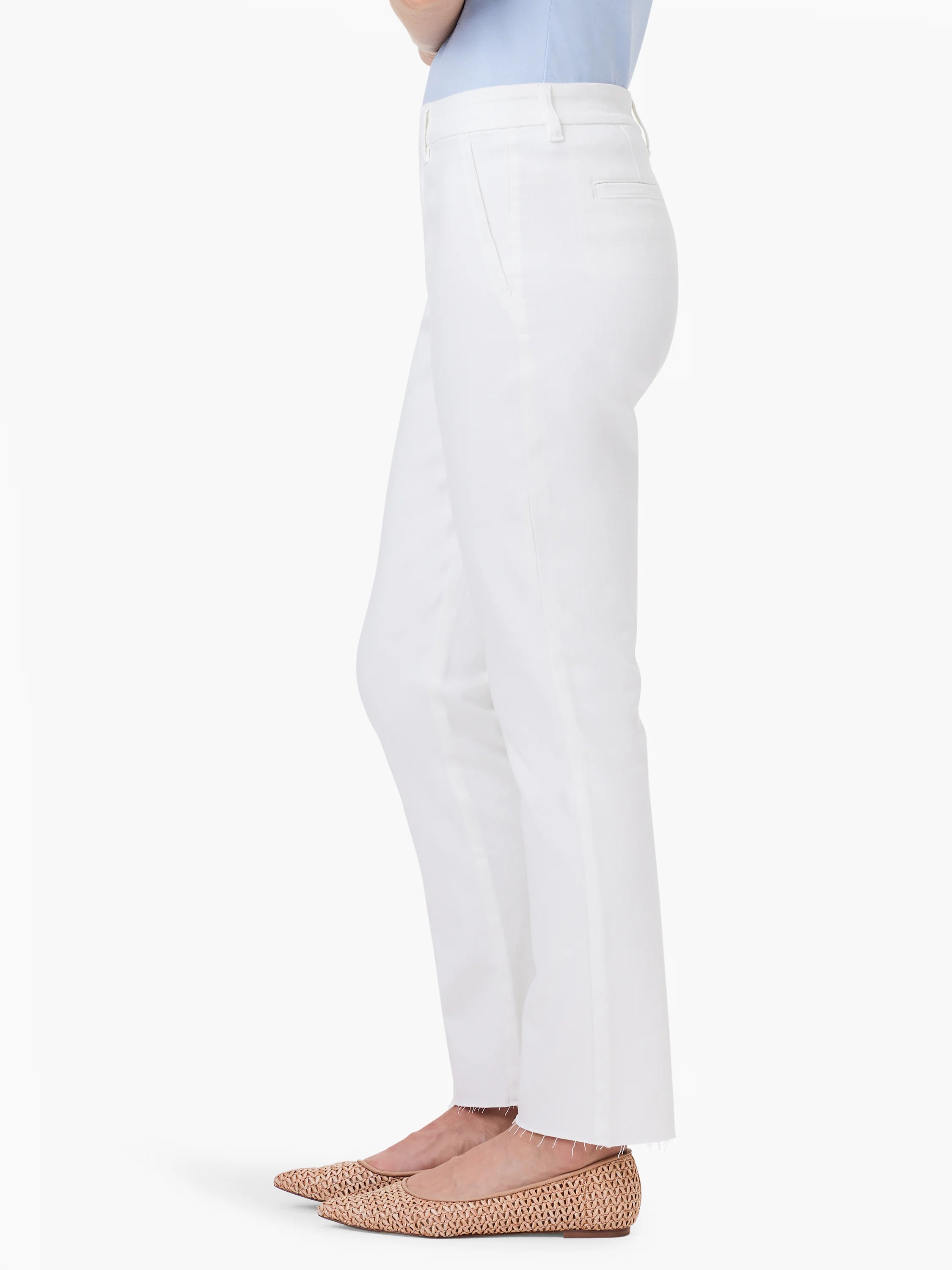 White straight ankle trousers with frayed hems, shown on a model from the side.