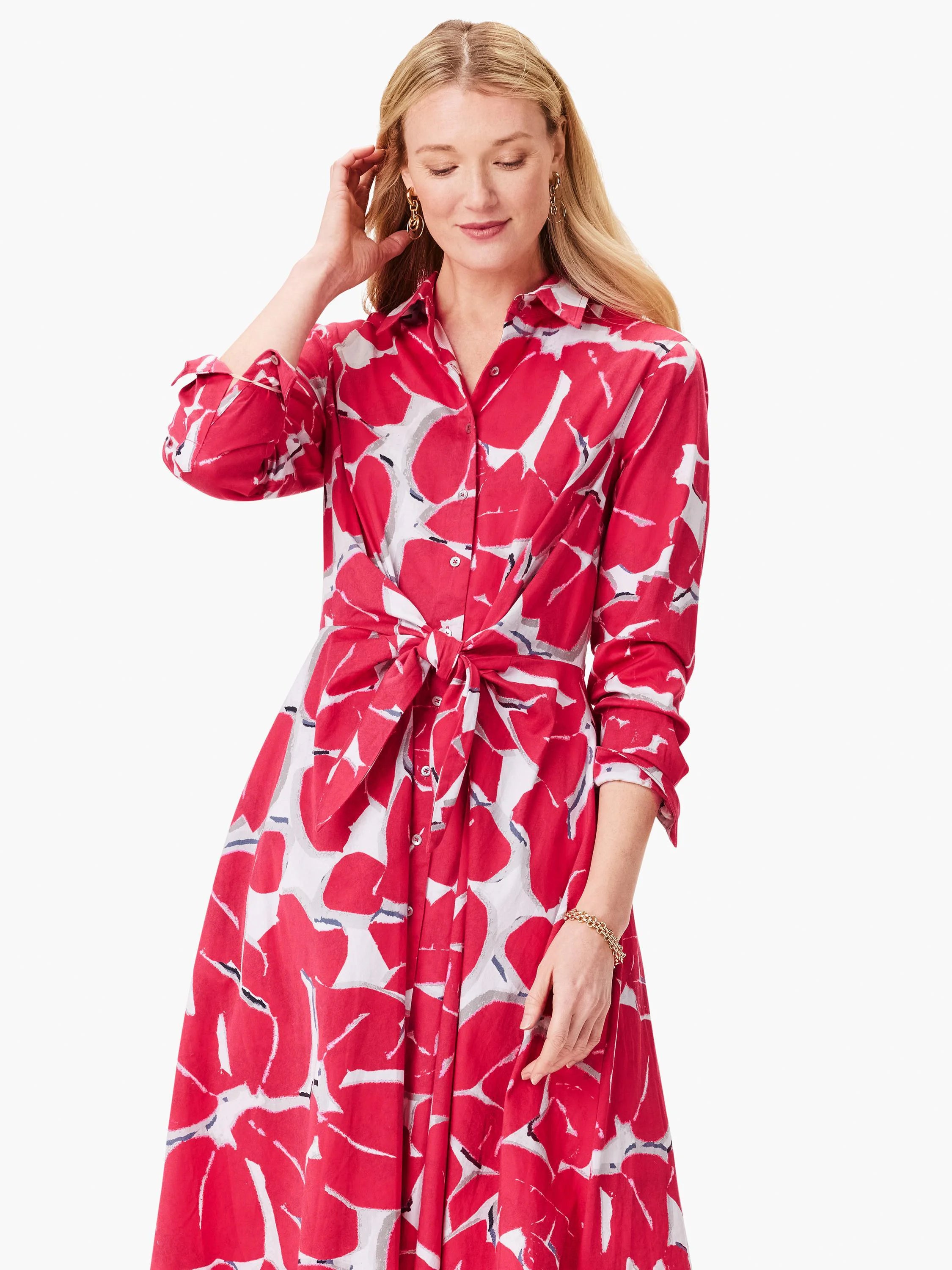 Pink floral shirt dress with long sleeves and a self-tie belt. White and gray accents in the print. Button front.