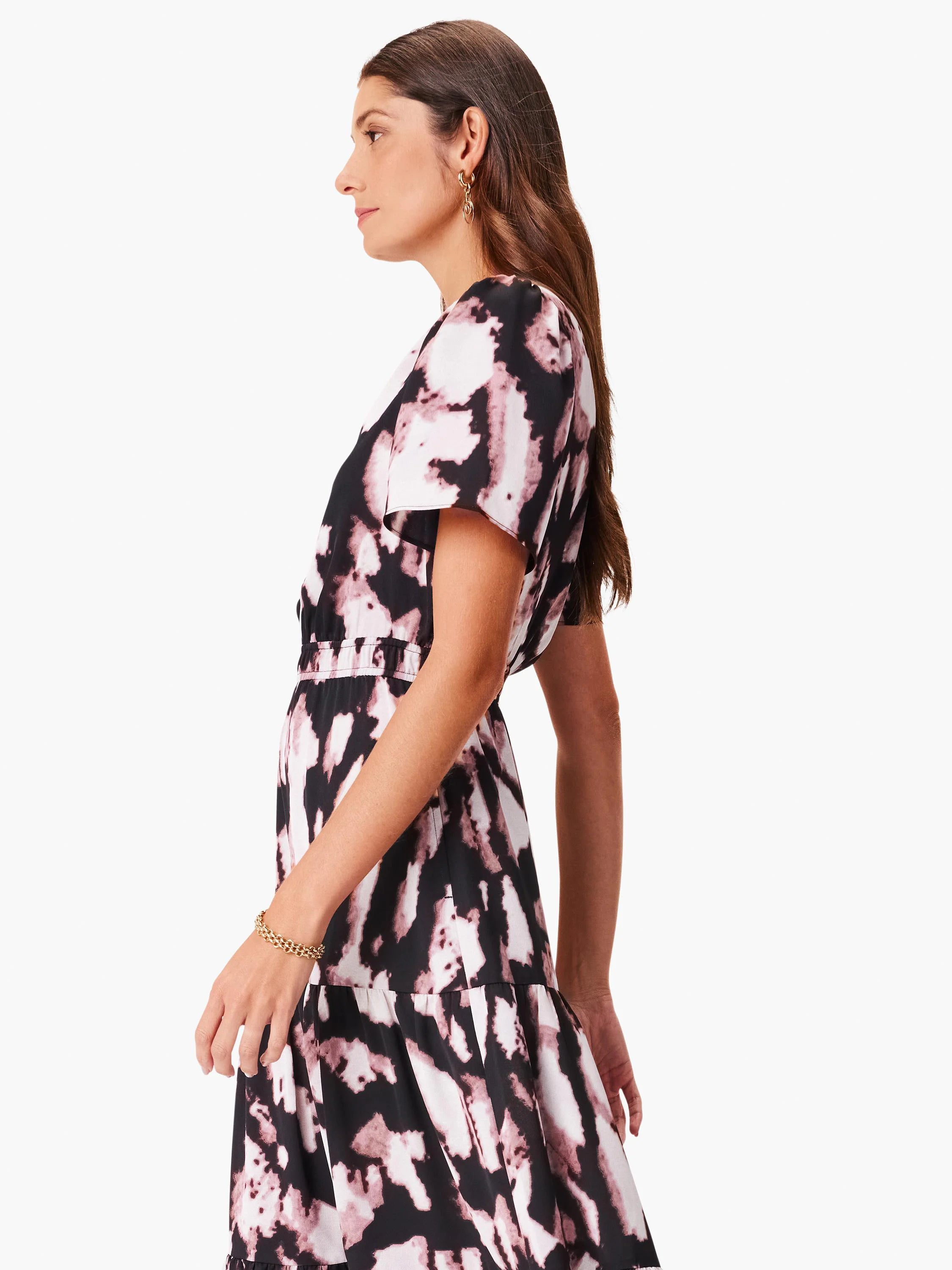 Short-sleeved tiered midi dress in black, mauve, and white abstract print.