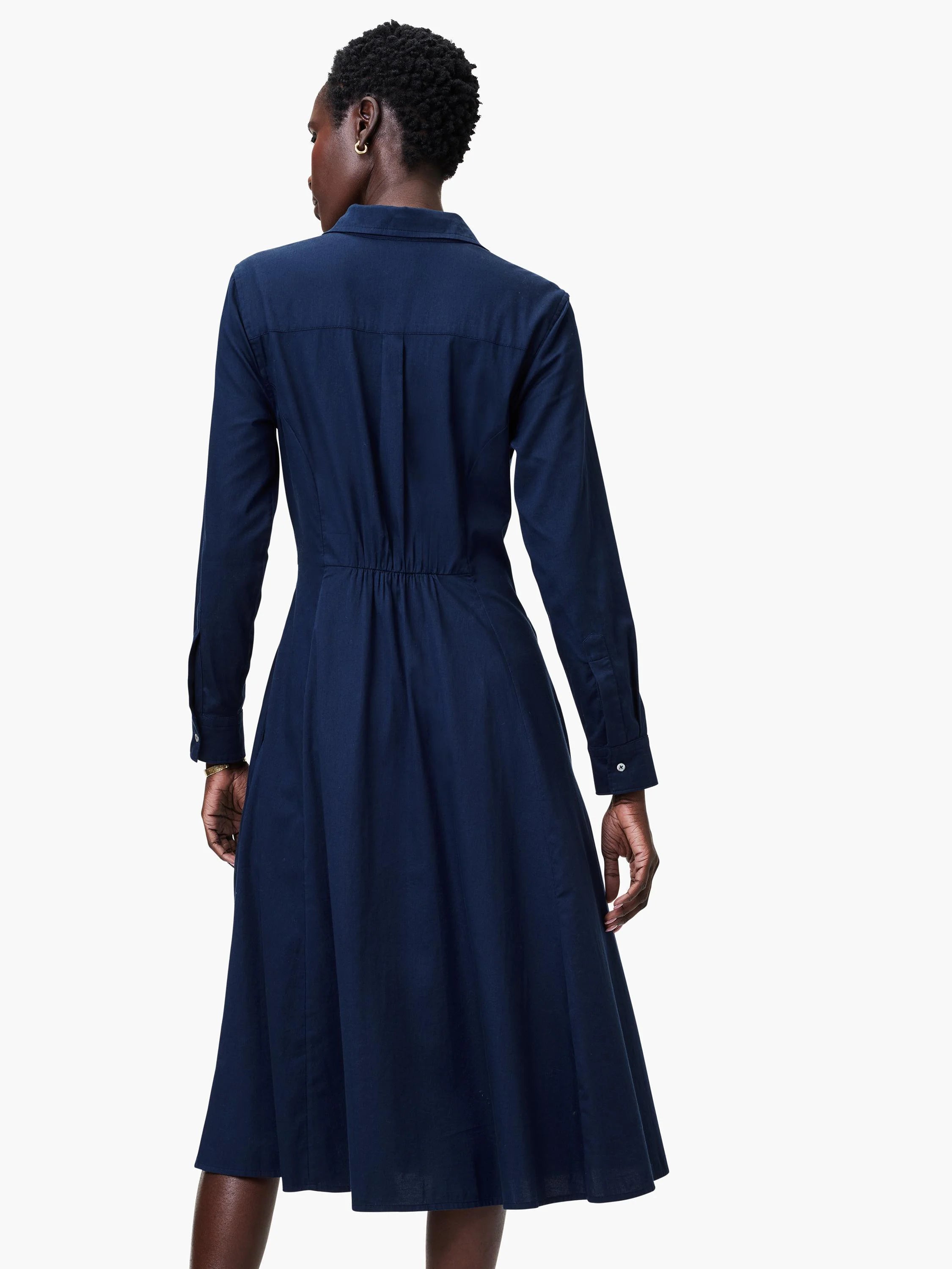 Navy blue midi shirt dress, long sleeves, collared, buttoned cuffs, fitted waist, A-line skirt.