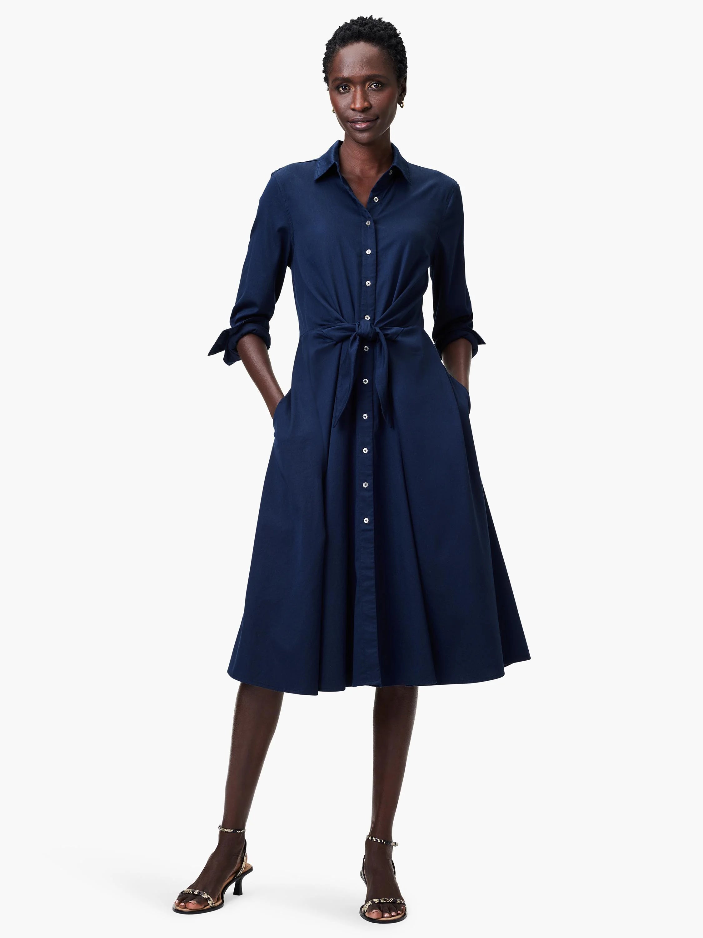 Navy blue midi shirt dress with a tie waist, button front, and pockets. A-line skirt.