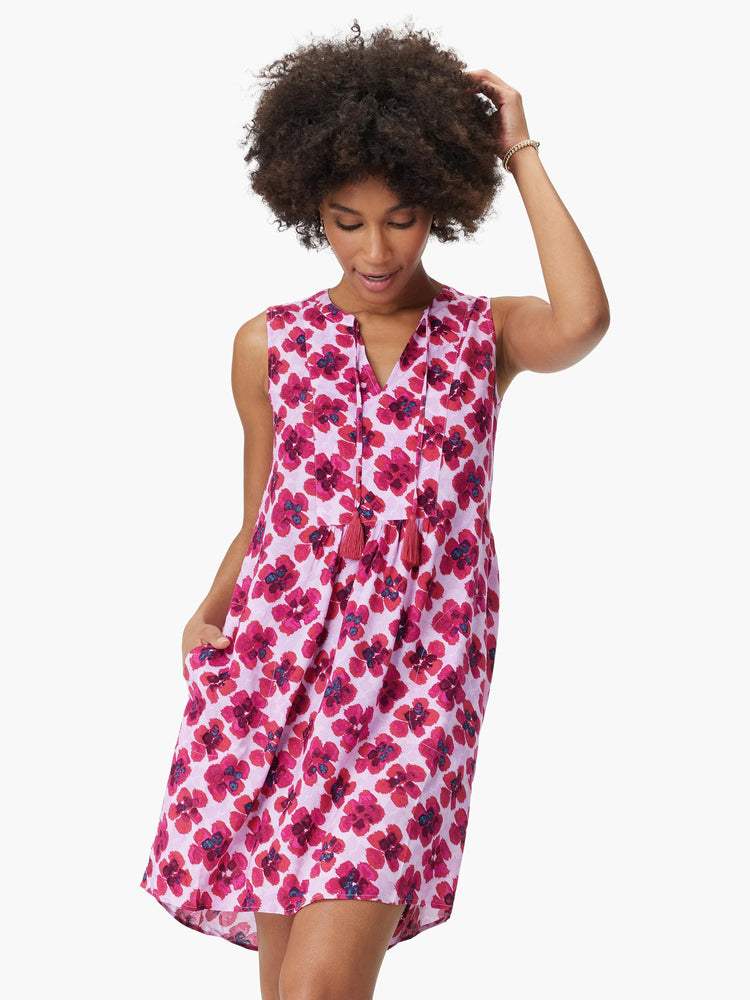 Sleeveless, lavender dress with a pink floral print, V-neck, and tassels. Features pockets.