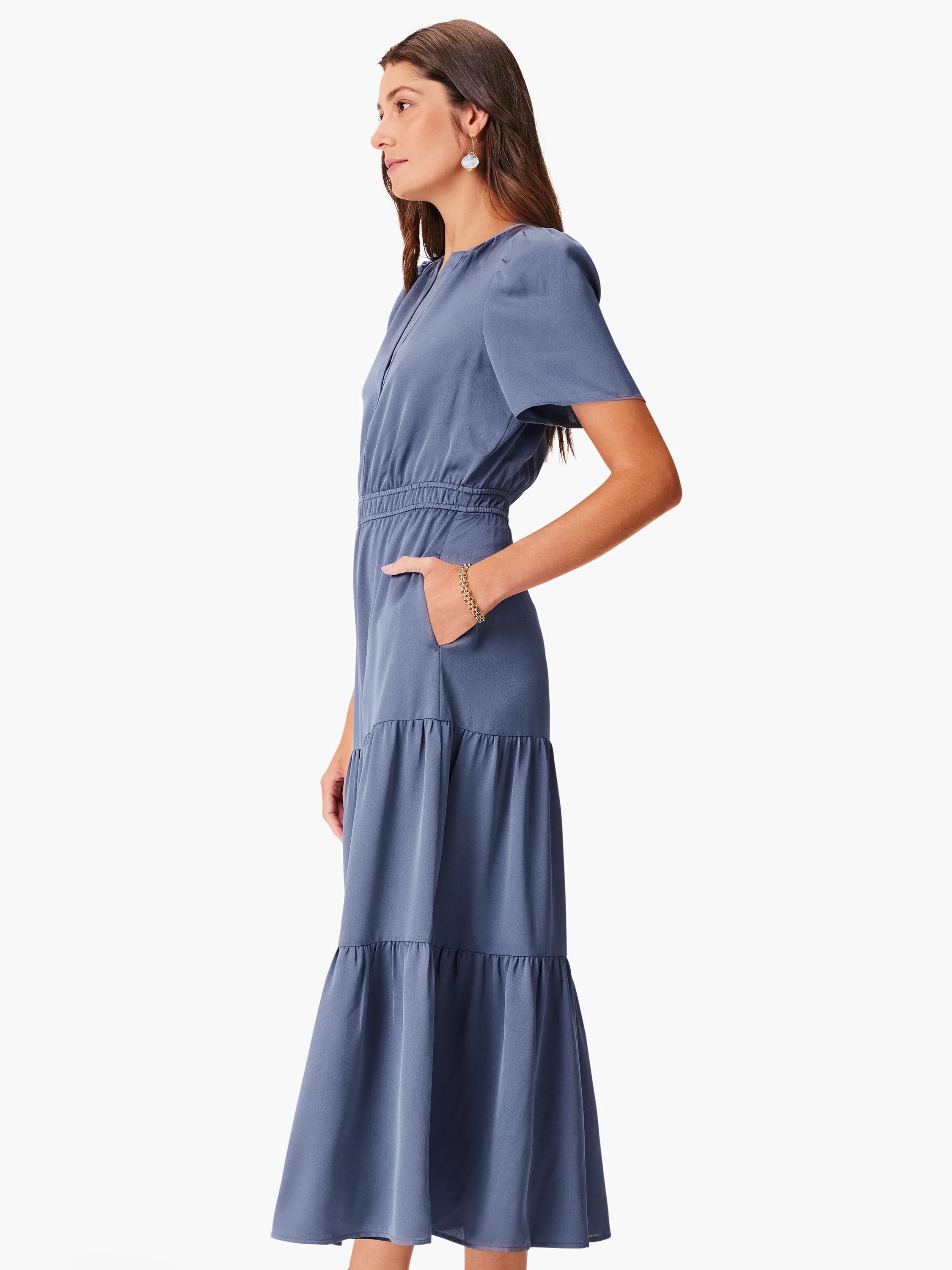 Dusty blue maxi dress with puff sleeves, shirred waist, tiered skirt, and pockets.