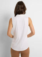 White sleeveless collared tank top, back view, with a vertical seam down the center.