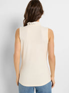 Off-white sleeveless tank with a ruffled mock neck, back view on a model.