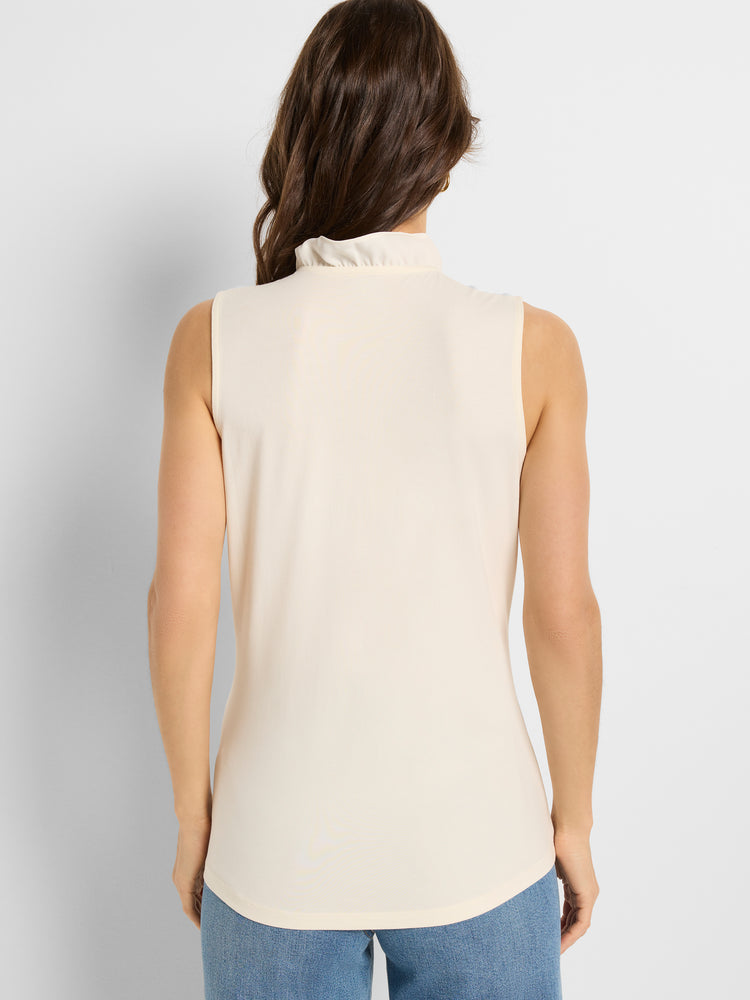 Model wears a cream sleeveless, semi-fitted top with a ruffled mock neck, captured from the rear view.