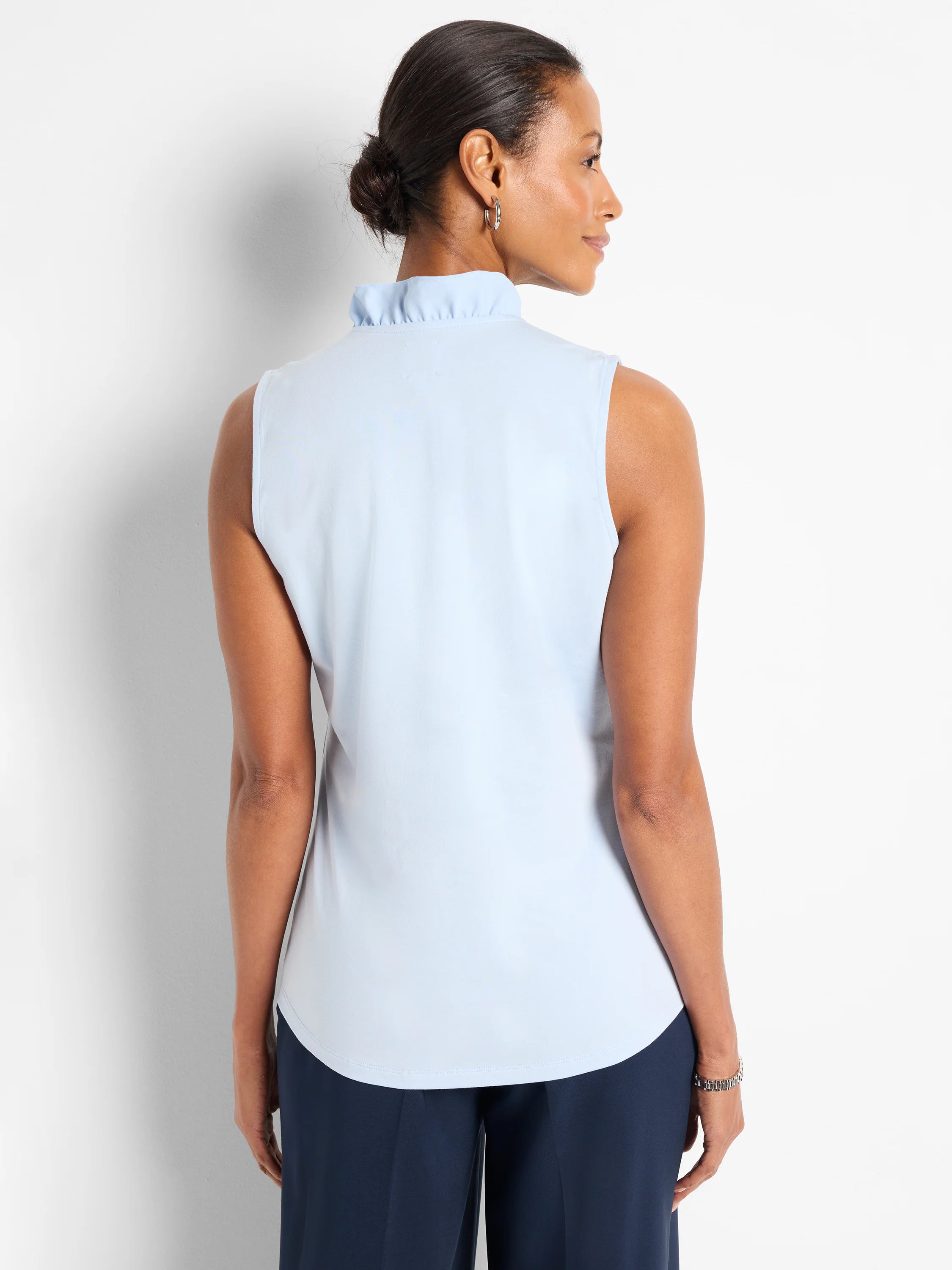 Light blue sleeveless tank with a ruffled mock neck.
