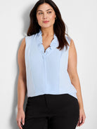 Light blue sleeveless tank with ruffles around the V-neckline.