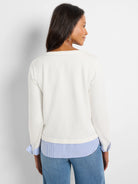 Off-white top with blue & white striped underlayer showing at hem & rolled cuffs. Blue stitching details.