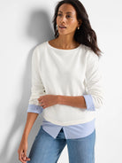 Off-white long-sleeve top with blue and white striped cuffs and hem, accented by blue stitching.