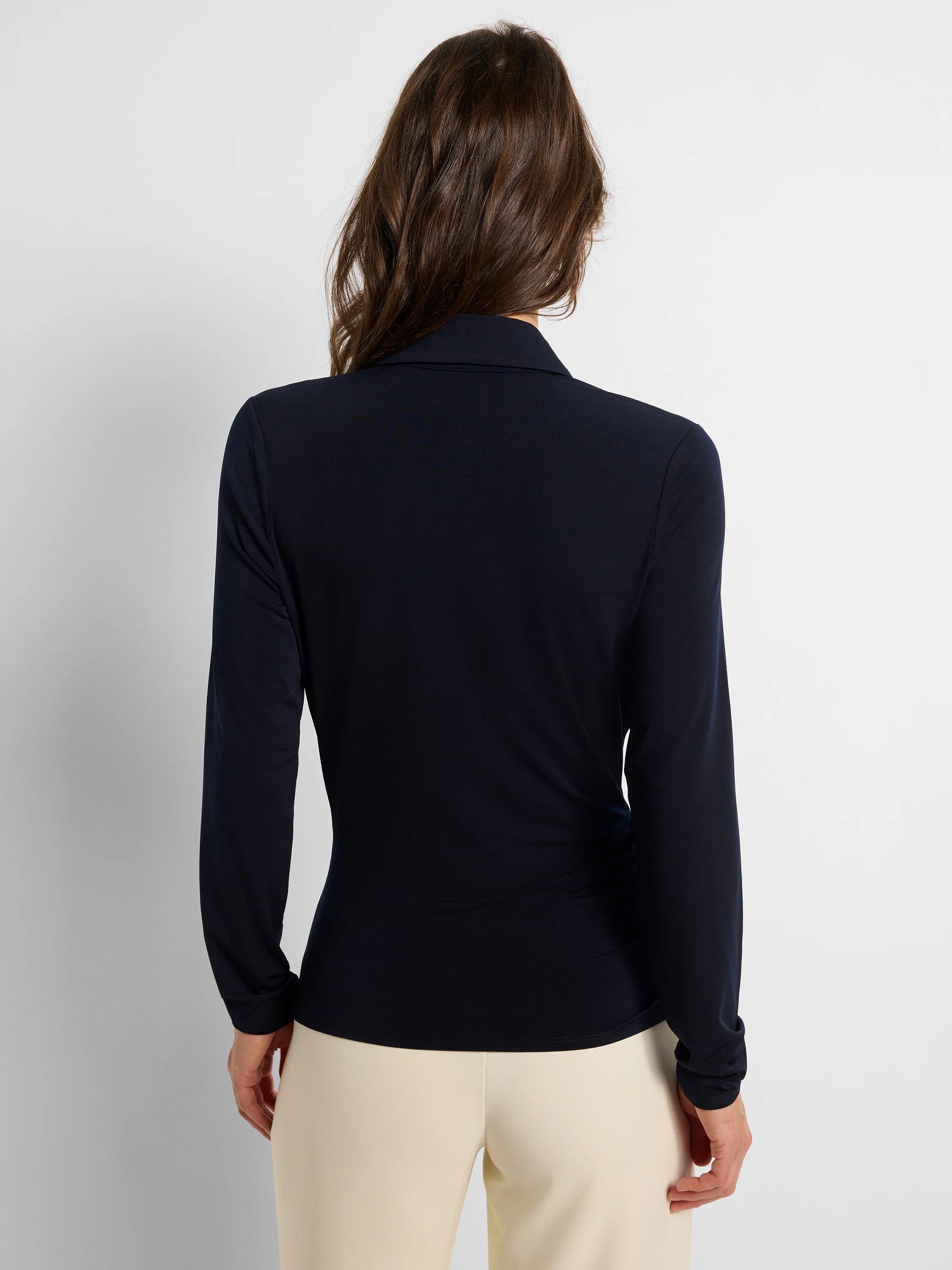 Dark blue collared wrap top with long sleeves, back view. Features subtle side gathering.
