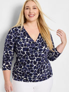 Navy & white irregular pebble pattern wrap top with V-neck, 3/4 sleeves, and side ruching.