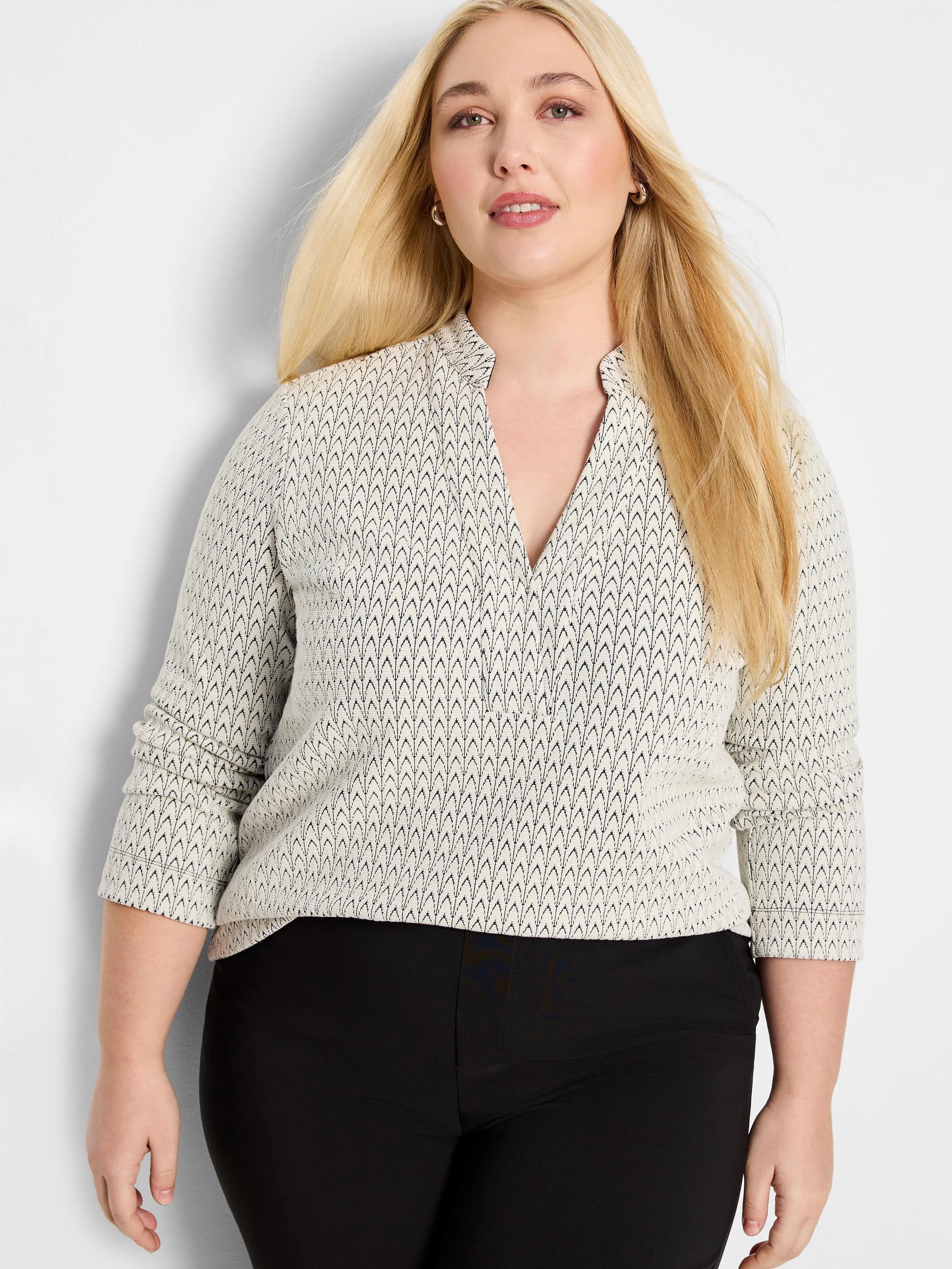 Off-white knit top with subtle dark swirl pattern, split V-neck, and 3/4 sleeves.