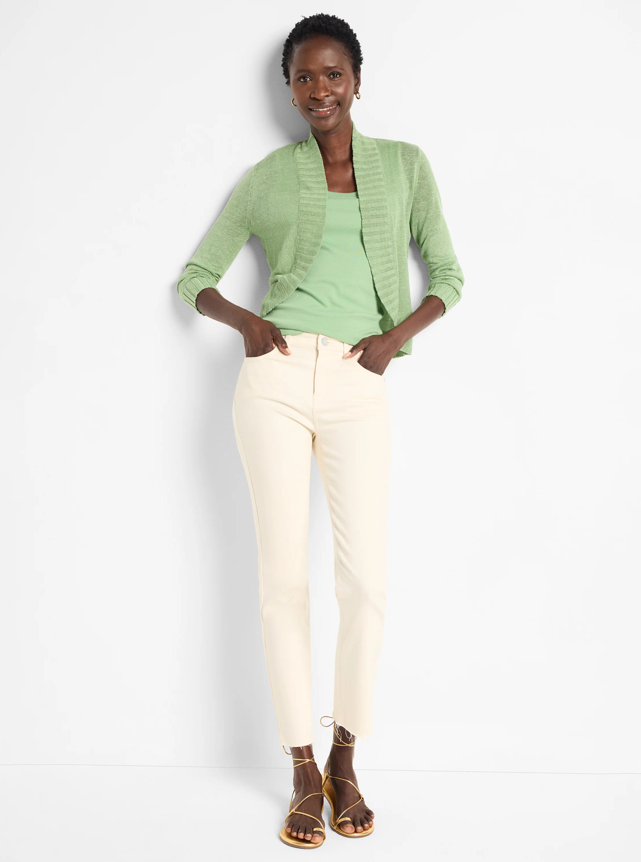 Model wears a light green ribbed scoop neck tank top.