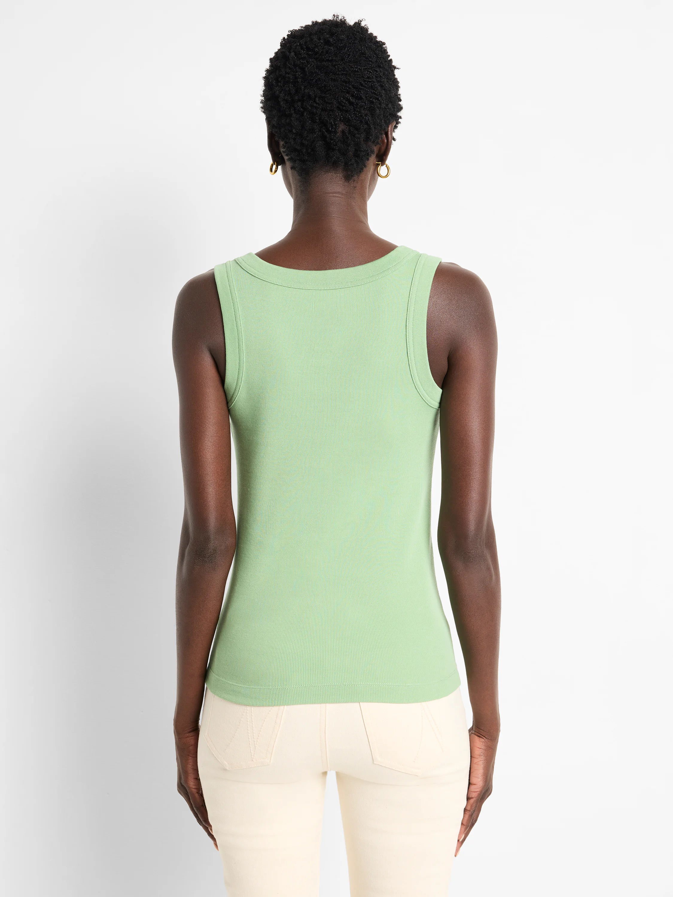Light green ribbed scoop tank top, seen from behind on a model.